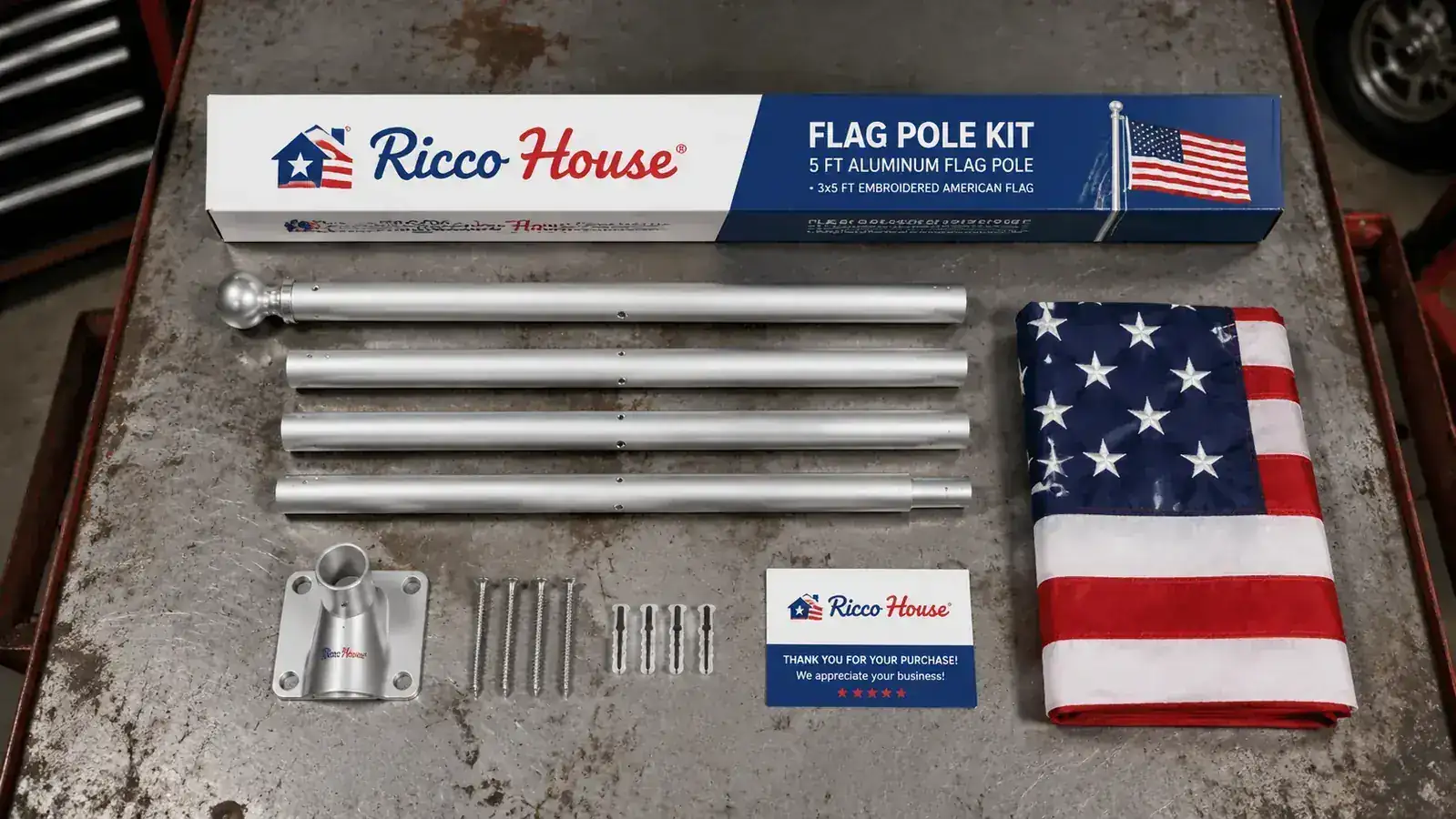 Ricco House flag pole kit laid out on a workbench showing the 5-foot pole, embroidered US flag, and mounting hardware