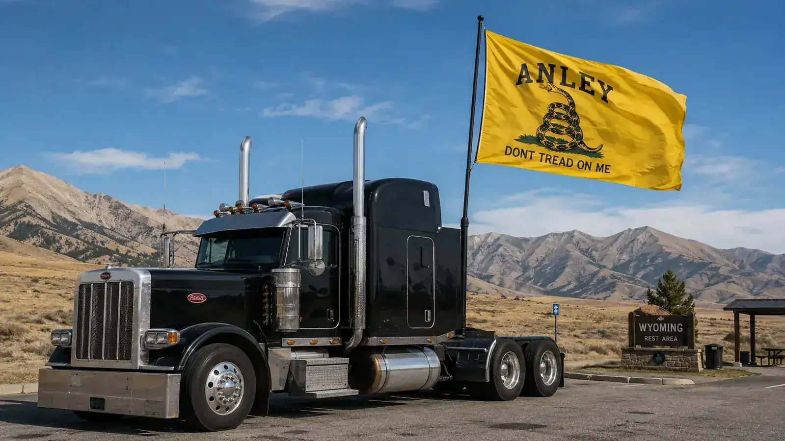 Close-up of the Anley Don't Tread on Me flag canvas header and brass grommets held in a trucker's weathered hand