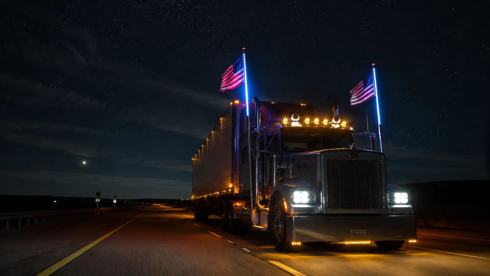 Semi truck at night on the highway with LED whip pole glowing, American flag illuminated, visible from distance