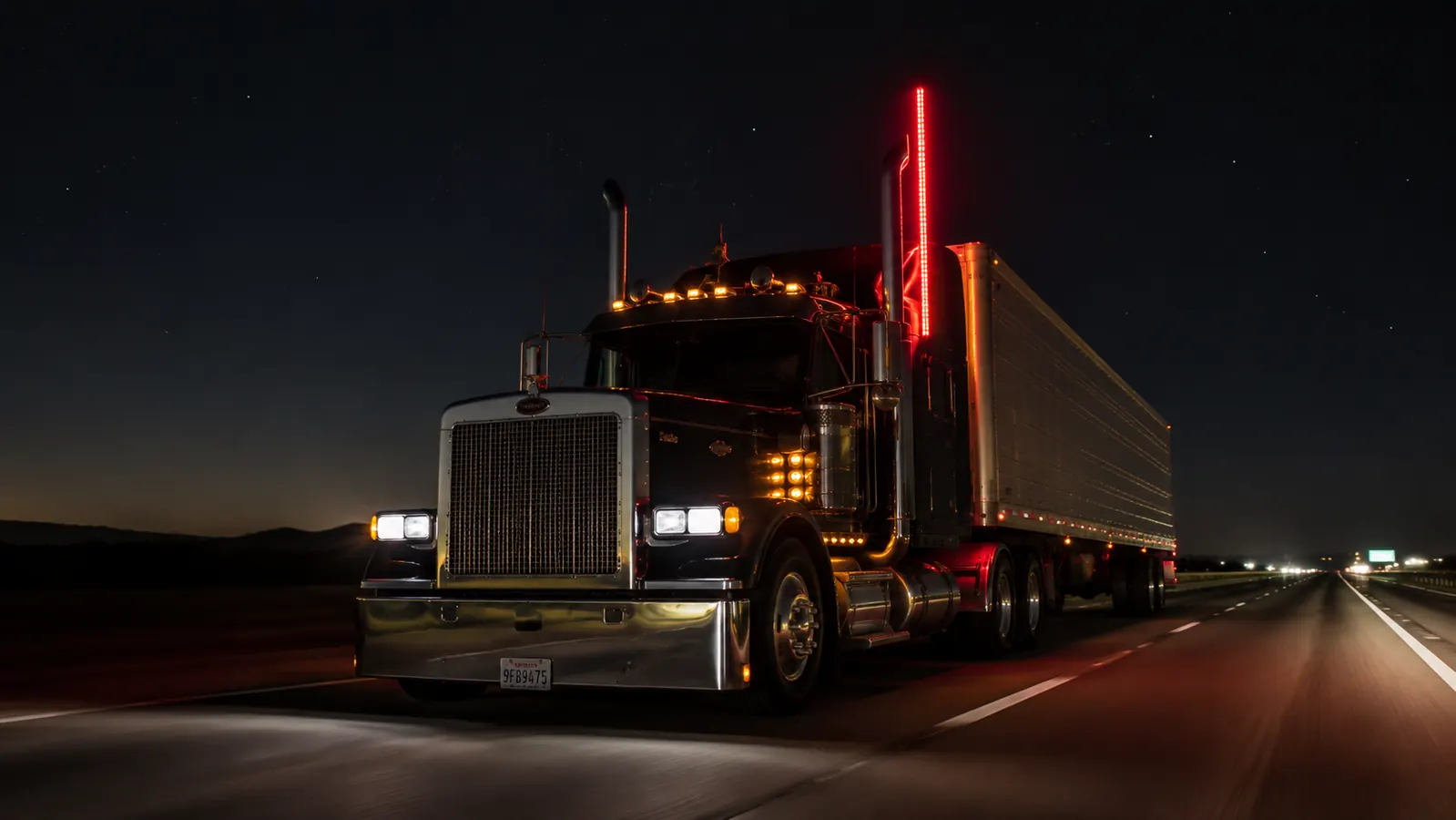 LED whip light mounted on a big rig driving at night on an empty interstate highway
