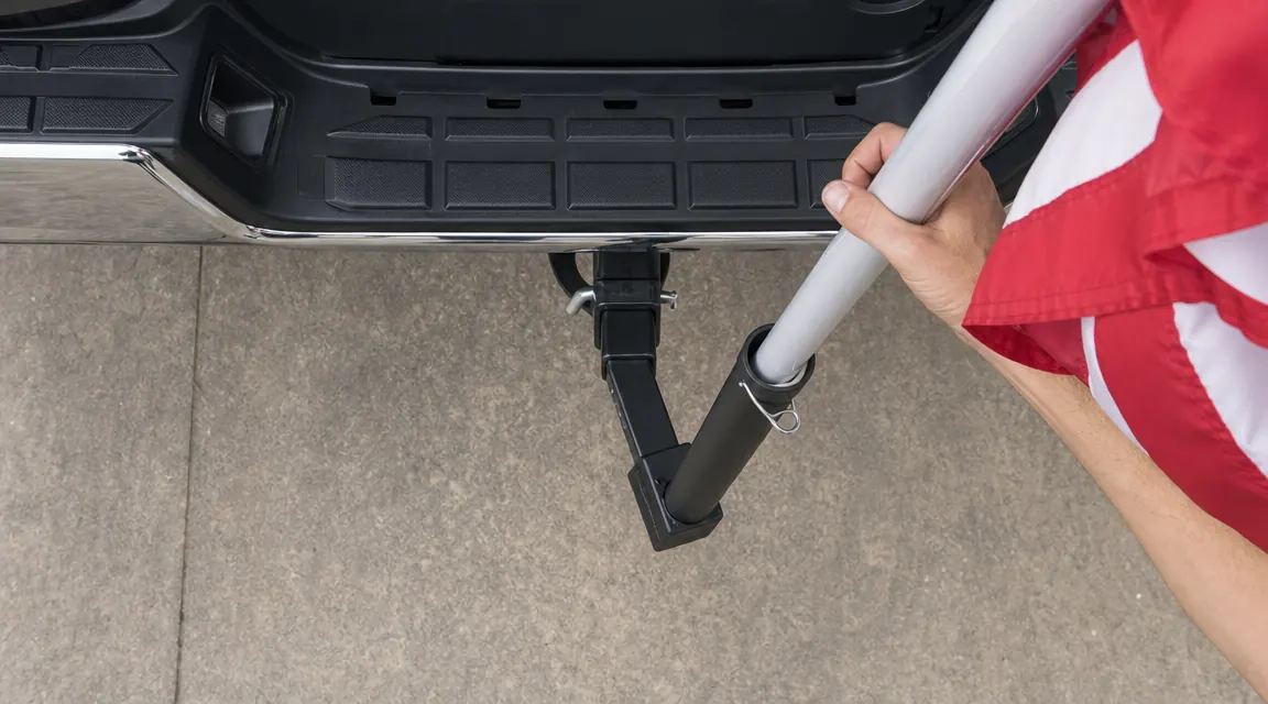 Overhead view of the UniExtra hitch mount installed in a truck receiver hitch, showing the flagpole angle and pole clamp detail